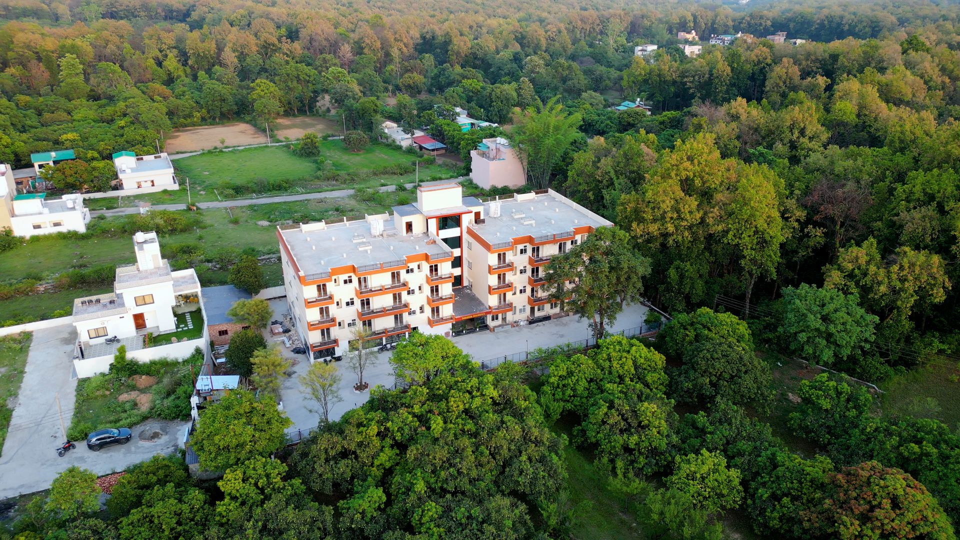 Takshila residential campus building surrounded by green hills in Dehradun, Uttarakhand